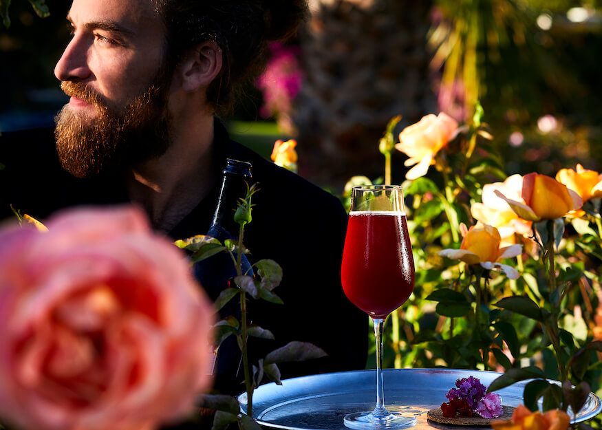 Nathan Otten, Head of bar in the garden with a red cocktail